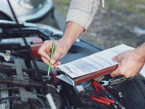 mechanic repairman checking a car engine car service